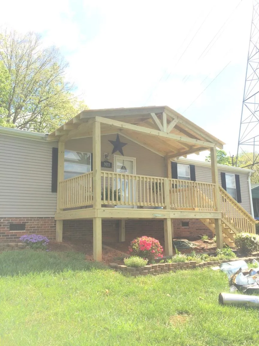 New gabled porch roof and deck railing added to a ranch home in Midway